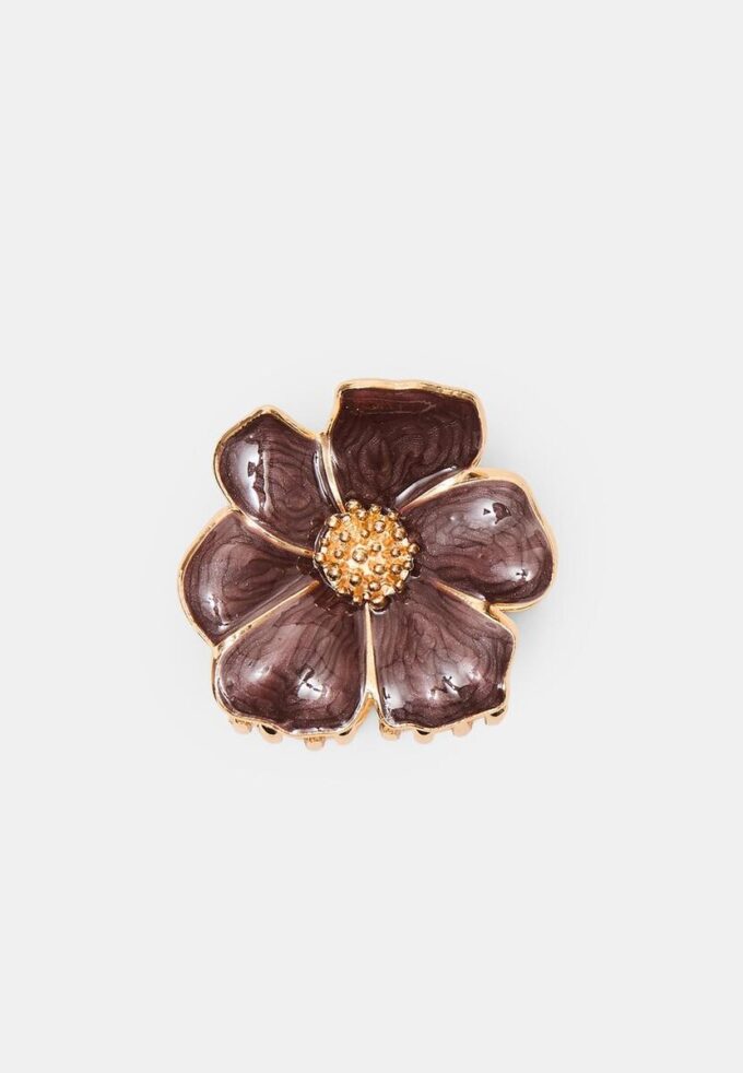 Hårspänne med metallisk blomma