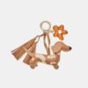Nyckelring med hund- och blomsterberlock