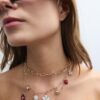 Set med 3 halsband med flera berlocker