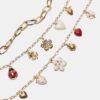 Set med 3 halsband med flera berlocker