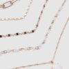 Set med 5 halsband med rosa stenar